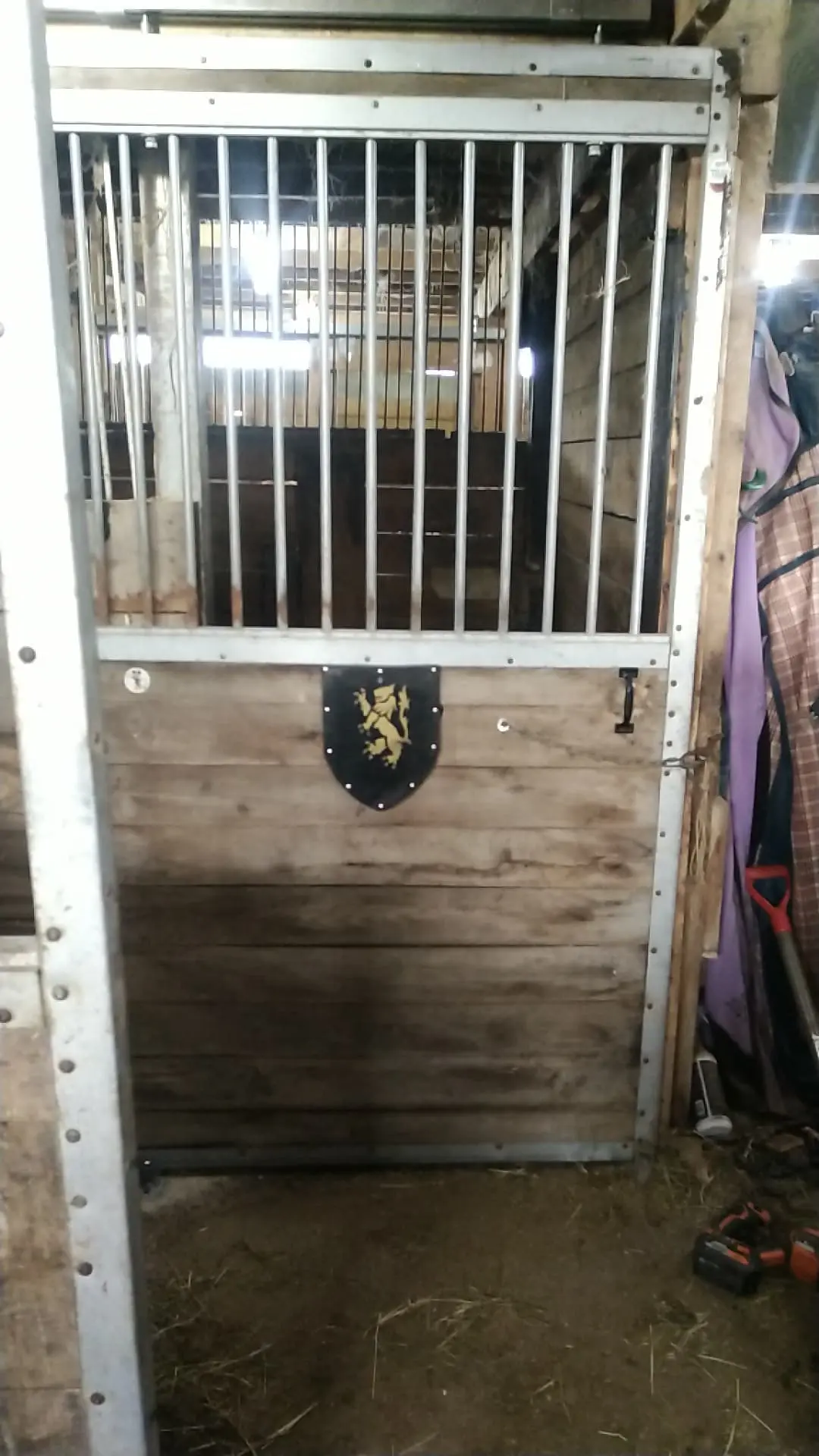 Sliding stall door with Shield hanging on it